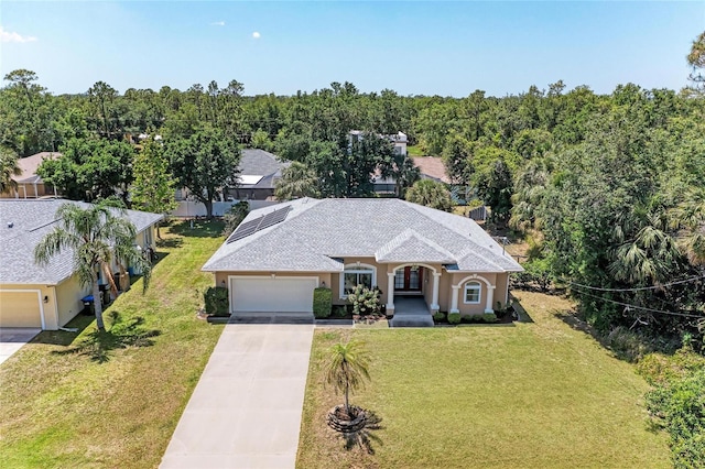 1631 Madison Ave, North Port, FL 34286 - view of front of property with a front yard, an attached garage, stucco siding, and concrete driveway