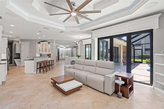 living room featuring crown molding, a ceiling fan, and a healthy amount of sunlight