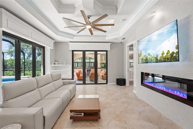 living area with crown molding, a ceiling fan, french doors, and a healthy amount of sunlight