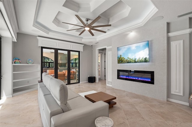 living room featuring ceiling fan, a glass covered fireplace, coffered ceiling, baseboards, and ornamental molding