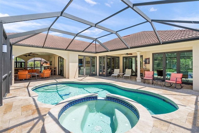 view of pool featuring ceiling fan, a patio area, outdoor lounge area, and a pool with connected hot tub