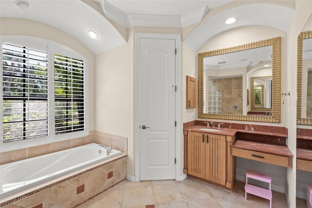 bathroom with a garden tub, vanity, and recessed lighting