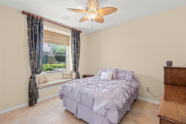 bedroom featuring light tile patterned floors, a ceiling fan, and baseboards