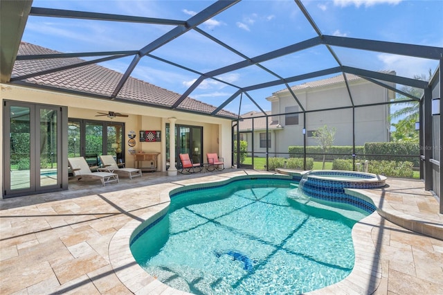 view of pool featuring ceiling fan, french doors, a pool with connected hot tub, and a patio area