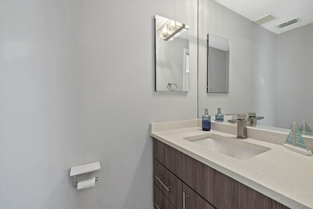 bathroom featuring visible vents and vanity