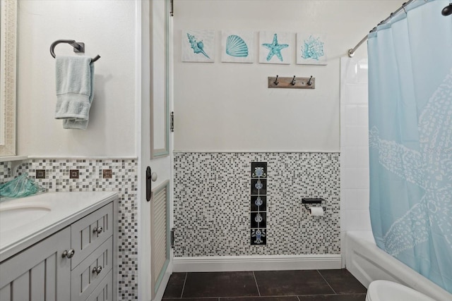 full bath featuring wainscoting, shower / bathtub combination with curtain, vanity, and tile patterned flooring