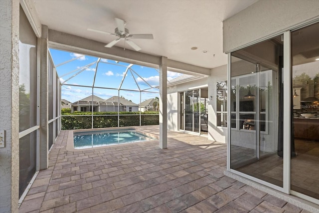 outdoor pool featuring a lanai, a patio area, and a ceiling fan