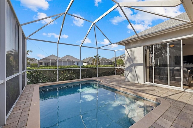 pool with a patio, a residential view, and a lanai