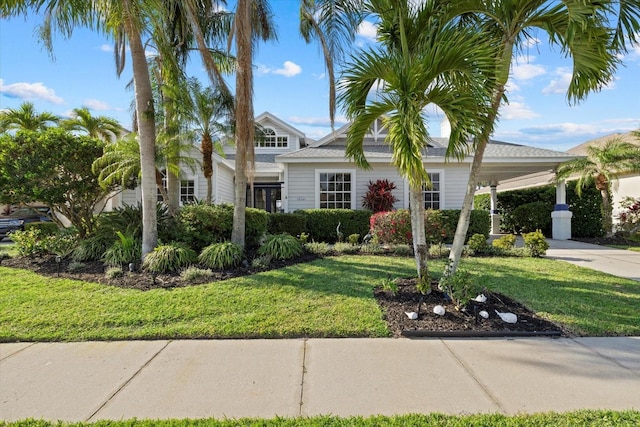 view of front of property featuring a carport, concrete driveway, and a front lawn