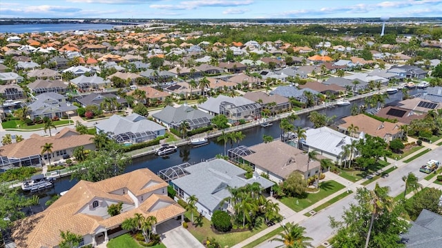 drone / aerial view featuring a residential view and a water view