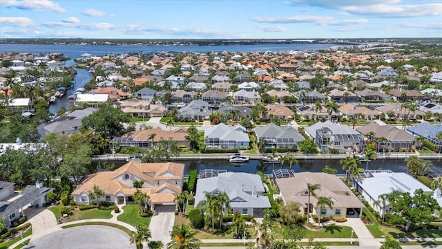 birds eye view of property with a residential view and a water view