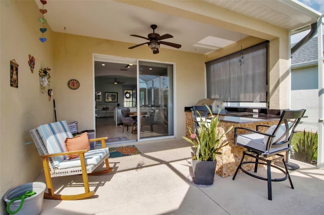 view of patio / terrace with an outdoor kitchen and ceiling fan