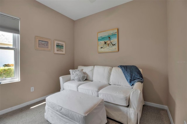 sitting room featuring carpet floors and baseboards