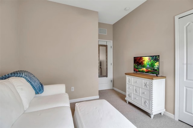 living room featuring light colored carpet and baseboards