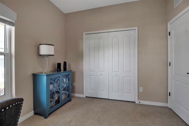 bedroom featuring carpet, baseboards, and multiple windows