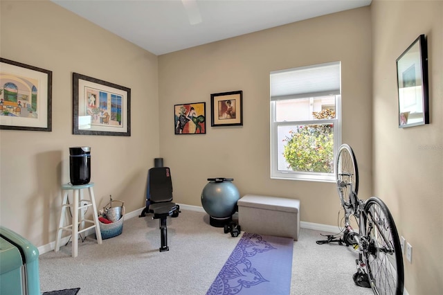 workout room featuring carpet floors, baseboards, and a ceiling fan