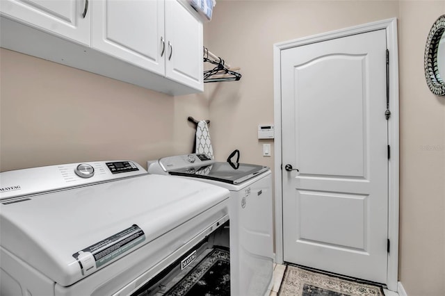 laundry room featuring cabinet space and separate washer and dryer