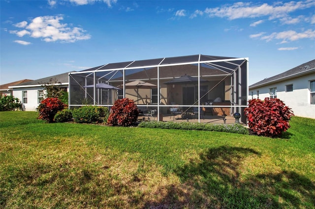 rear view of house featuring a lawn and a patio