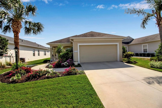 single story home featuring an attached garage, a front yard, concrete driveway, and stucco siding