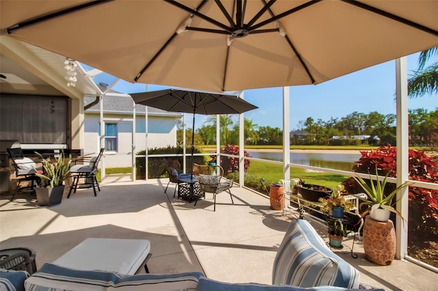 view of patio featuring a water view and outdoor dining area