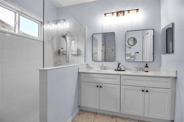full bath with a walk in shower, double vanity, and tile patterned flooring