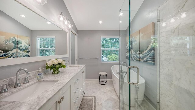 5324 Siesta Ct, Sarasota, FL 34242 - full bathroom with a soaking tub, a healthy amount of sunlight, double vanity, and a sink