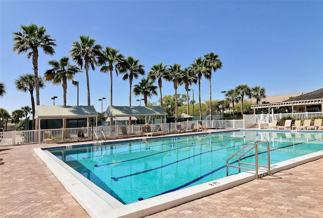 pool featuring a patio area and fence