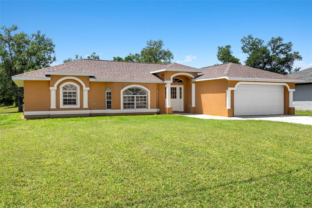 27255 Deep Creek Blvd, Punta Gorda, FL 33983 - view of front of house with a garage, a front yard, stucco siding, and concrete driveway