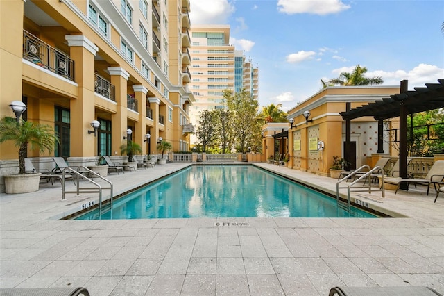 community pool with a pergola and a patio
