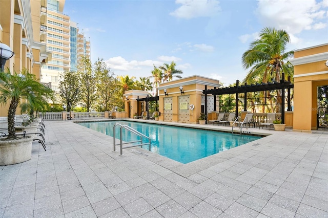 pool with fence and a patio area