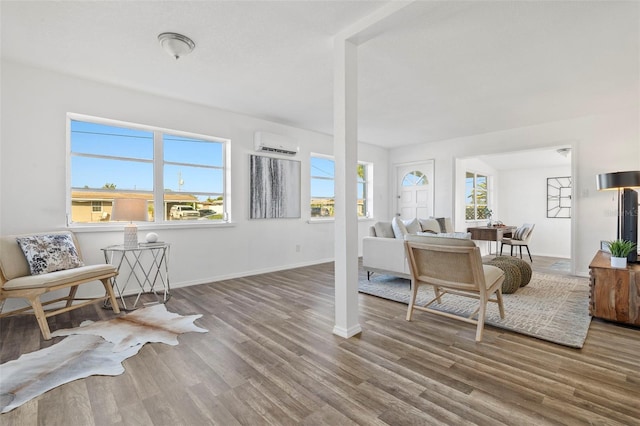 221 Duxbury Ave, Port Charlotte, FL 33952 - living room with baseboards, an AC wall unit, wood finished floors, and a wealth of natural light