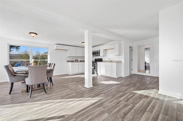 221 Duxbury Ave, Port Charlotte, FL 33952 - dining room featuring baseboards and wood finished floors
