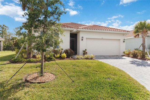 412 Dalily Blvd, Nokomis, FL 34275 - mediterranean / spanish-style house with an attached garage, a tiled roof, decorative driveway, a front lawn, and stucco siding