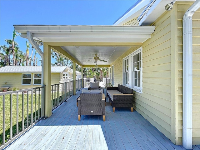 deck featuring outdoor lounge area and a ceiling fan