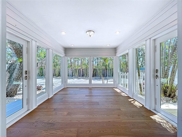 unfurnished sunroom with plenty of natural light and wood finished floors