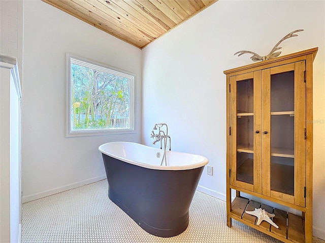 full bathroom featuring baseboards, wooden ceiling, and a soaking tub