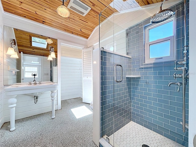 bathroom with wood ceiling, vaulted ceiling, a stall shower, and a healthy amount of sunlight
