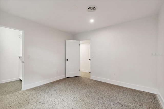 3610 Pershing Ave, Orlando, FL 32812 - empty room with speckle patterned floor, baseboards, and recessed lighting