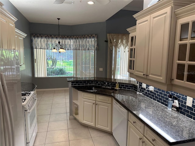 3312 92nd Ave E, Parrish, FL 34219 - kitchen featuring white appliances, light tile patterned flooring, decorative light fixtures, glass insert cabinets, and a peninsula