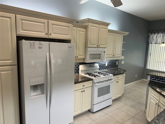 3312 92nd Ave E, Parrish, FL 34219 - kitchen featuring white appliances, tasteful backsplash, light tile patterned floors, and dark stone countertops