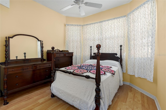 3312 92nd Ave E, Parrish, FL 34219 - bedroom with wood finished floors and a ceiling fan