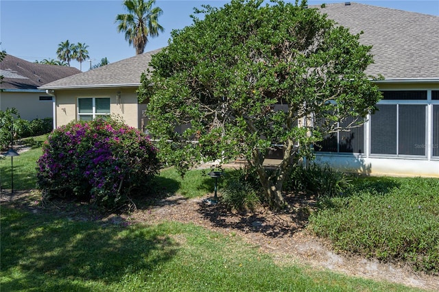 3312 92nd Ave E, Parrish, FL 34219 - view of property exterior featuring a yard, roof with shingles, and stucco siding