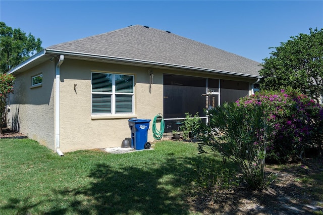 3312 92nd Ave E, Parrish, FL 34219 - back of property featuring stucco siding, a yard, and a sunroom