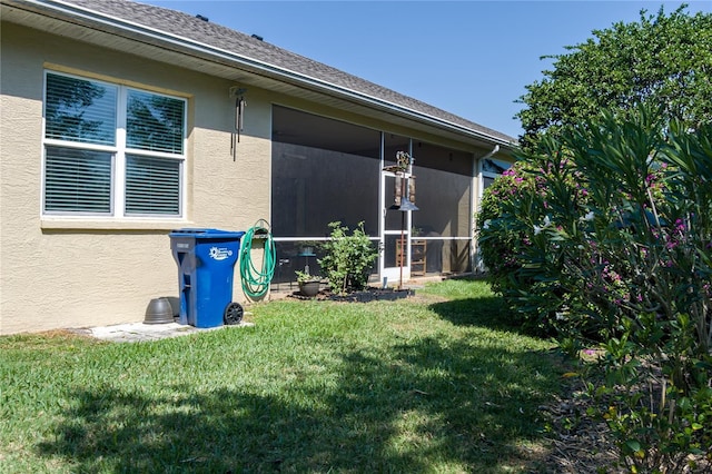 3312 92nd Ave E, Parrish, FL 34219 - view of property exterior featuring a sunroom, stucco siding, and a yard