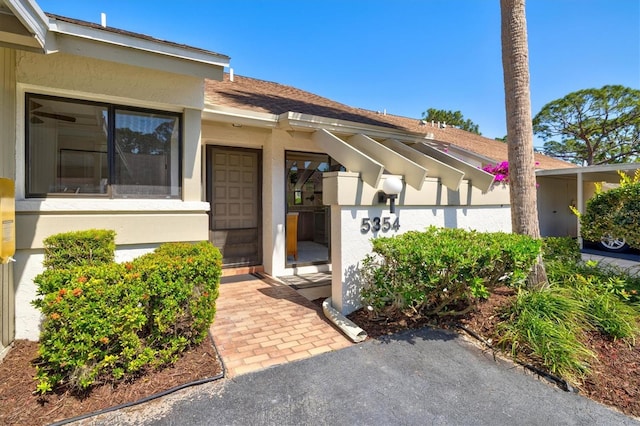 entrance to property with stucco siding