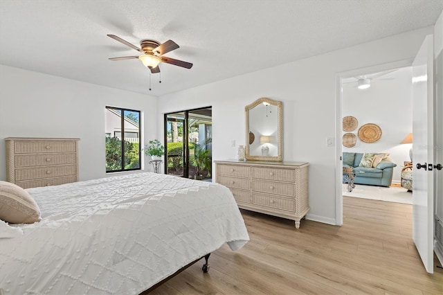 bedroom featuring light wood-style flooring, a ceiling fan, and baseboards