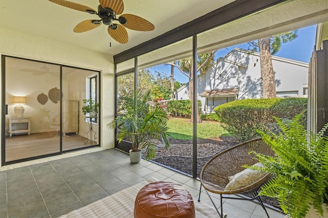 sunroom with a healthy amount of sunlight and ceiling fan