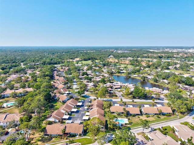 drone / aerial view with a water view and a residential view