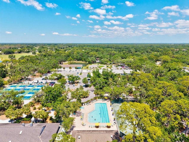 drone / aerial view featuring a wooded view
