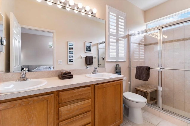 bathroom with a stall shower, a sink, tile patterned floors, toilet, and connected bathroom
